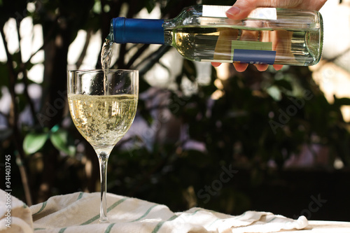 glass of white Italian wine in the garden close up 