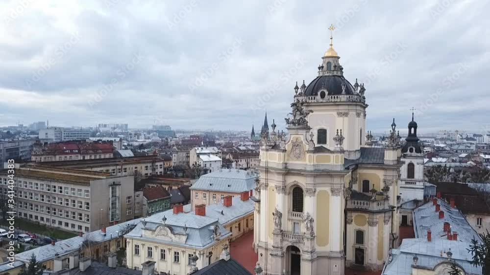 A beautiful view of the church with dark domes and yellow walls in the middle of the center of a city in Lviv. Archcathedral Cathedral of St. George A beautiful view of the church with dark domes and yellow walls in the middle of the center of a city in Lviv. Archcathedral Cathedral of St. George