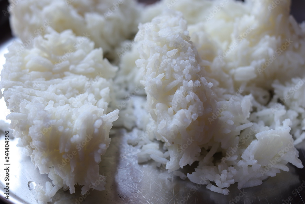 Eating rice isolated on steel plate Eating rice isolated on steel plate