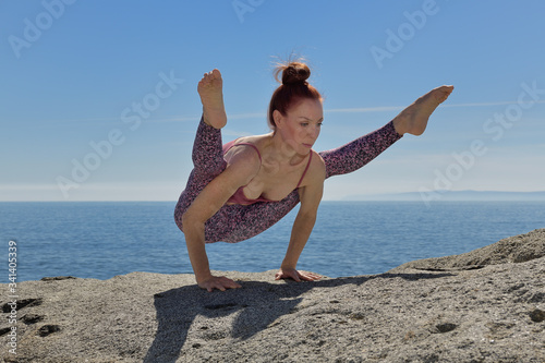 Portrait of a fit woman who practices yoga outdoors. Woman practicing asanas on a sunny day