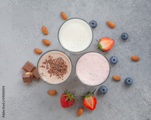 Assorted protein cocktails with fresh fruits, berries and chocolate. Protein shake. Sports nutrition and healthy lifestyle concept. Top view.