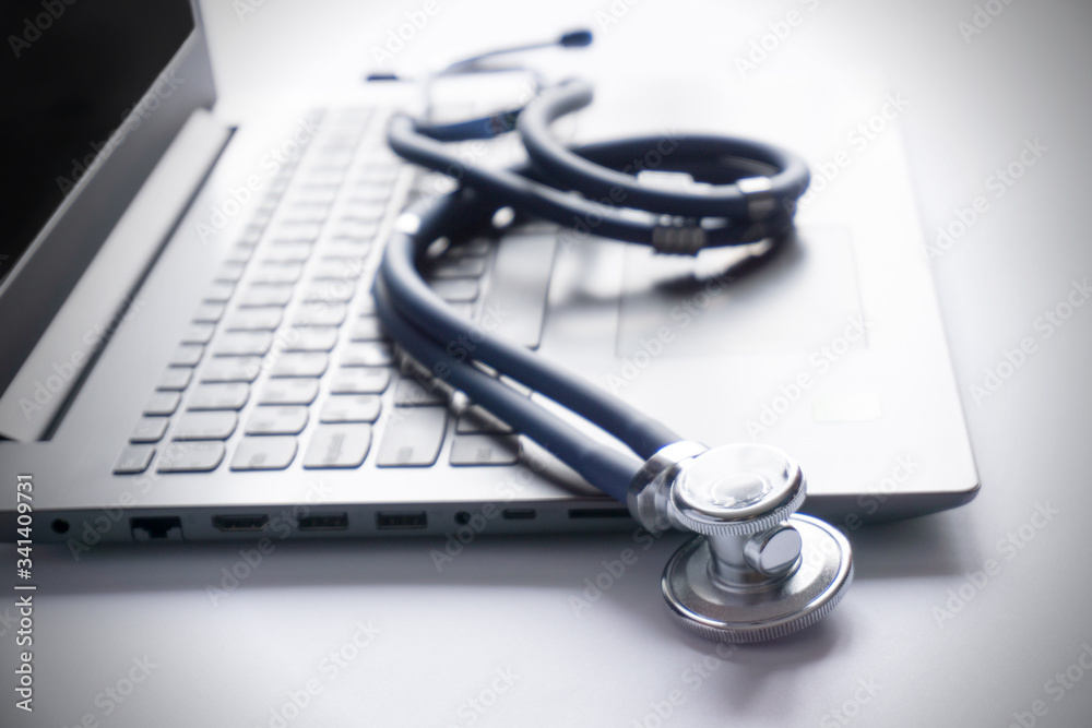 stethoscope lay on computer with pen and glasses, documents. work spase of doctor. stethoscope lay on computer with pen and glasses, documents. work spase of doctor.