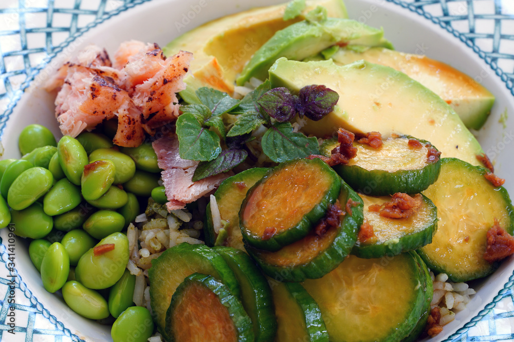 Asian green rice bowl with edamame, cucumber, avocado,shiso, and salmon Asian green rice bowl with edamame, cucumber, avocado,shiso, and salmon