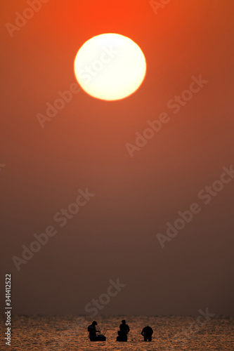 People fishing at Asker beach during sunrise in the morning