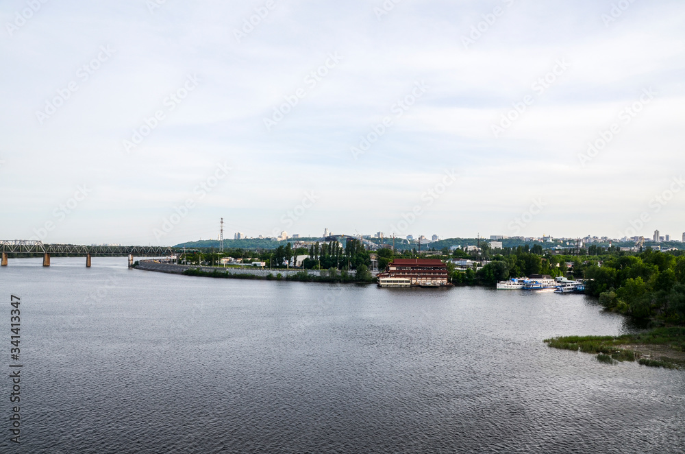 View of the industrial embankment and Petrovsky railway bridge over the Dnipro River in Kyiv, Ukraine