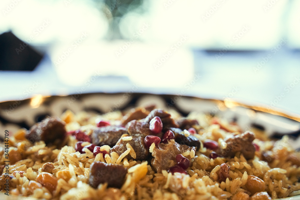 Pilaf in a plate on wooden background, top. A big pilaf pan bowl with mix of vegetables , cooking on the kitchen Pilaf in a plate on wooden background, top. A big pilaf pan bowl with mix of vegetables , cooking on the kitchen