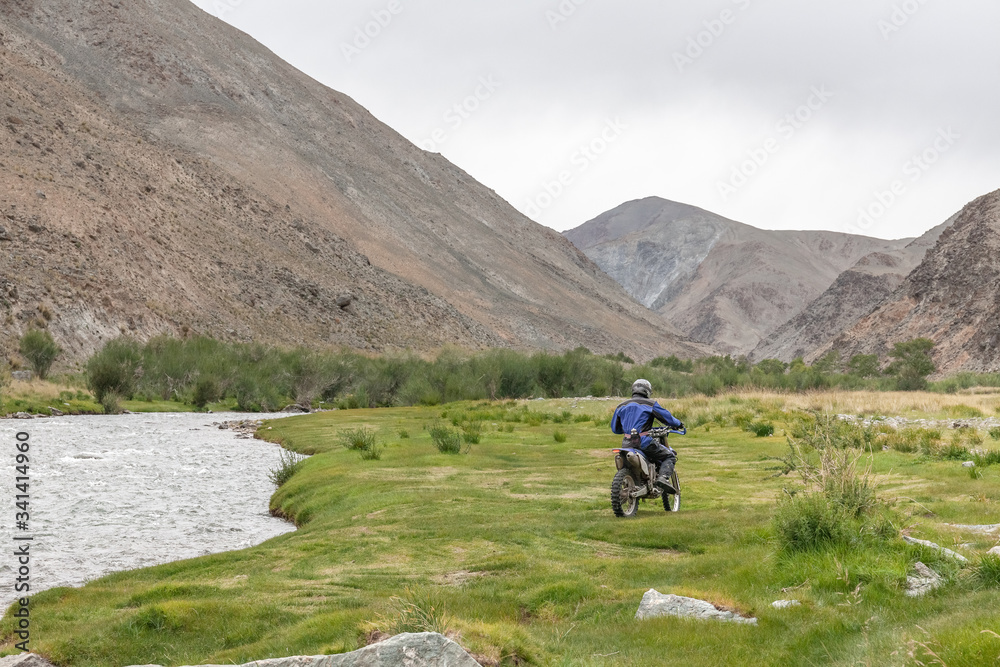 Tourists in the middle of the trees grow in the rocky soil of the Mongolian mountains. Mongolian landscapes in the Altai Mountains, wide landscape.