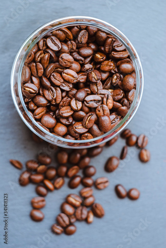 Coffee beans in a jar on a dark background, close-up
