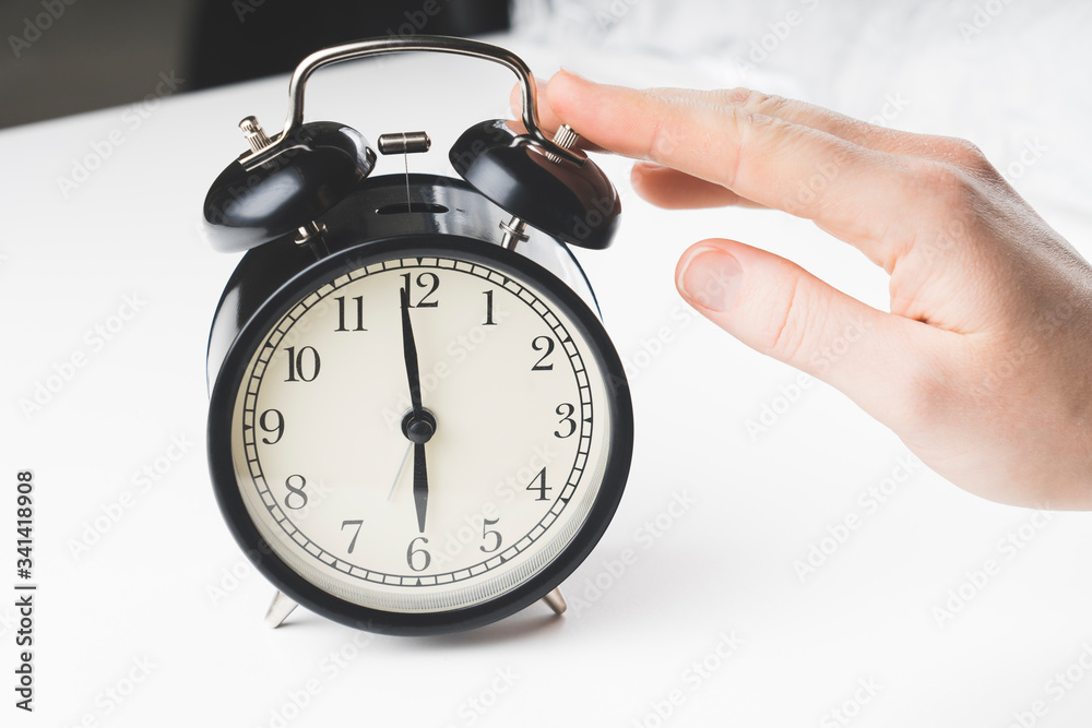 sets the alarm, women's hands set the time and set the alarm on black vintage alarm clocks , concept, selective focus, tinted image, sets the alarm, women's hands set the time and set the alarm on black vintage alarm clocks , concept, selective focus, tinted image,