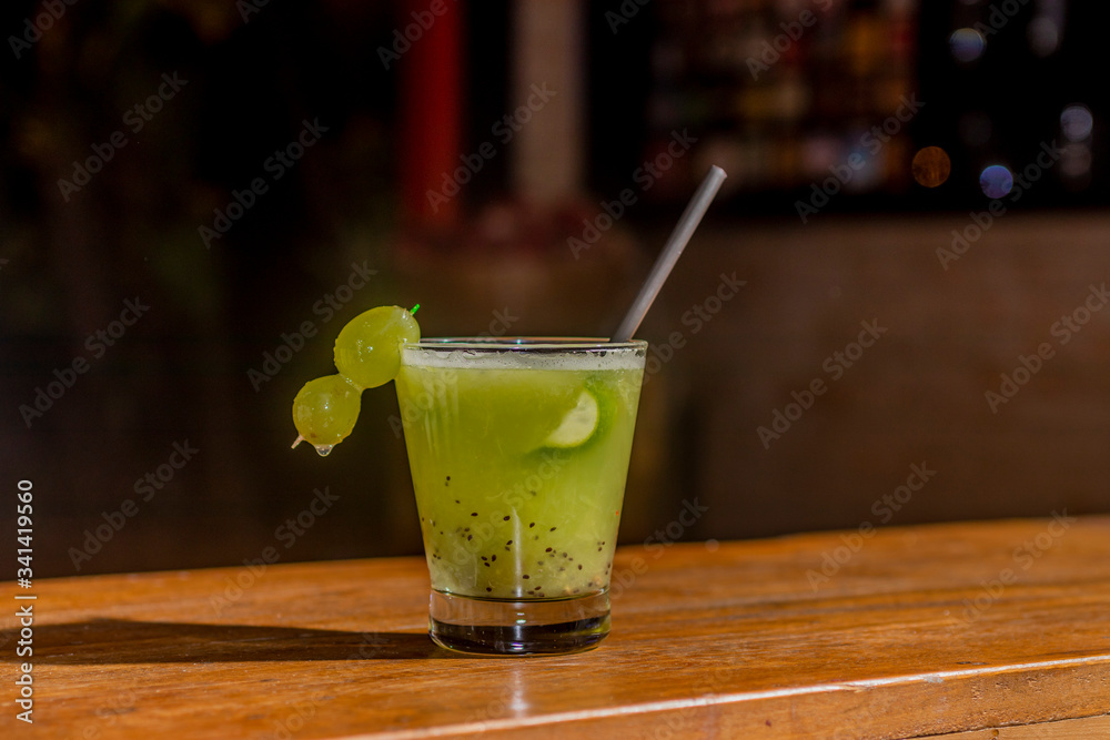 grape fruits brazilian caipirinhas made of lemon and grape in glass. grape fruits brazilian caipirinhas made of lemon and grape in glass.