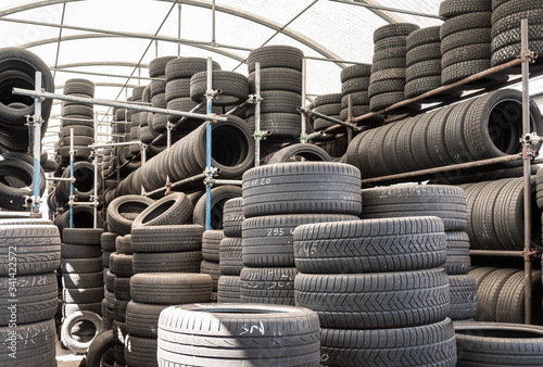 Stack of used tires in a car garage of installation service.