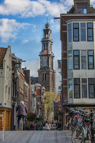 Tourists on the street with view of Westerkerk church tower photo