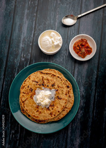 stuffed dal paratha with curd, pickle and white butter 