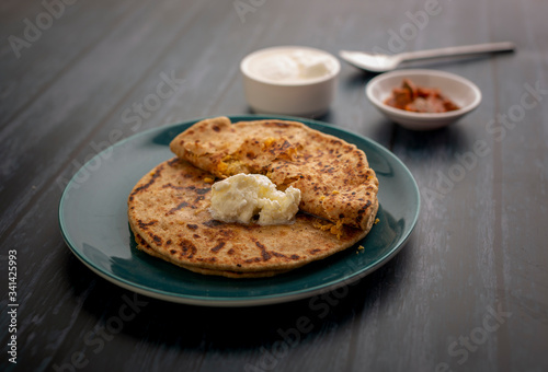 stuffed dal paratha with curd, pickle and white butter 