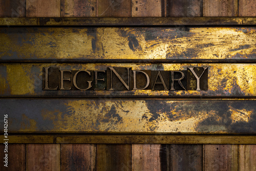 Photo of real authentic typeset letters forming Legendary text on vintage textured grunge copper and gold background