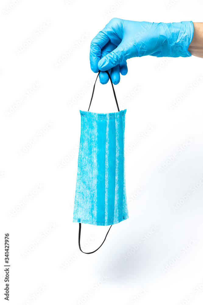 Hands with protective masks and latex gloves