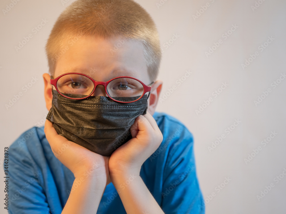 Two boys in dirty medical masks are quarantined at home. Children cough hard and get dirty with masks quickly. concept of fight against coronavirus epidemic and proper prevention of infections