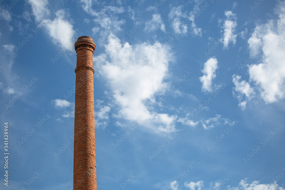 View of a industrial chimney made with orange massive brick