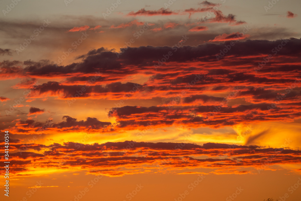 Ciel en feu avec des nuages rouges et orange au couché du soleil