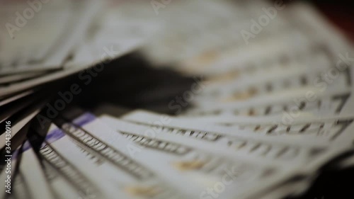 Wallpaper Mural Hundred-dollar bills lie on top of each other and spin, taken close-up Torontodigital.ca