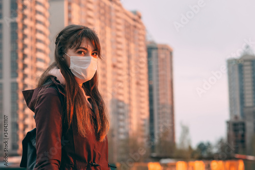 COVID-19 Pandemic Coronavirus Woman in city street wearing face mask protective for spreading of disease virus SARS-CoV-2. Girl with protective mask on face against Coronavirus Disease 2019.