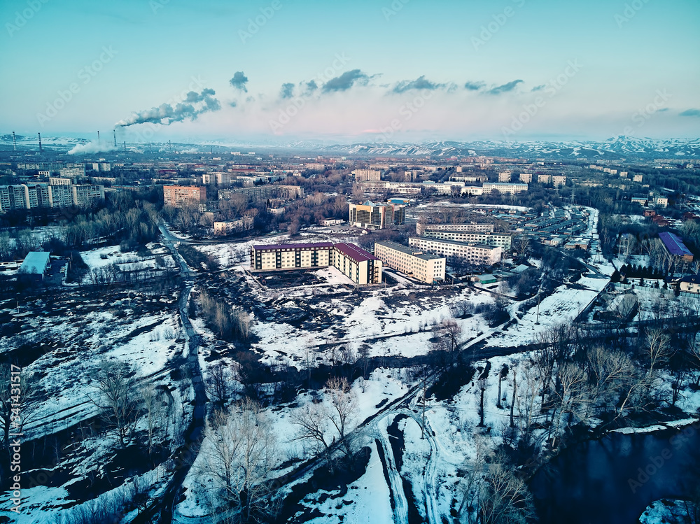 Panoramic aerial view: beautiful spring landscape: the Irtysh river in Kazakhstan wakes up from winter sleep - ice drift - snow and ice are melting at sunset