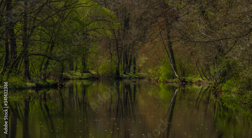 Blanice river with color green trees near weir in Bavorov town