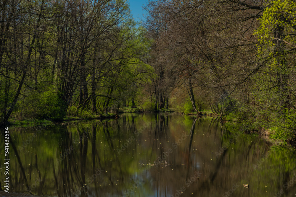 Blanice river with color green trees near weir in Bavorov town