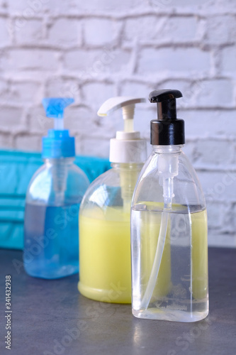 hand sanitizer and liquid soap on black background 