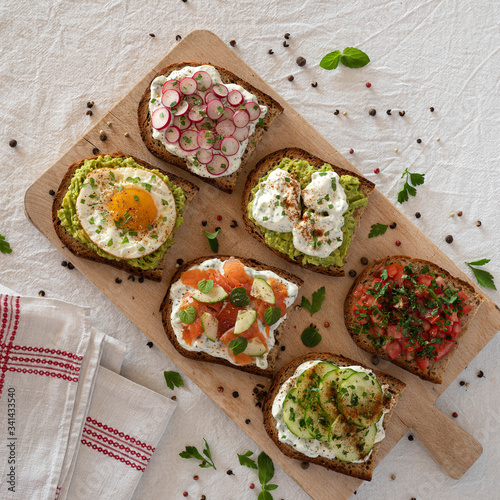 Set of aperitif sandwiches with avocado, egg, salmon ...
 photo