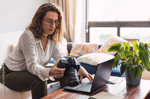 female photographer observes her photos on her camera 