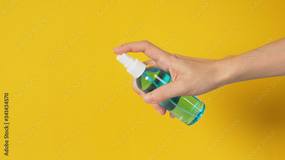 Fototapeta premium Hand is holding Alcohol Spray on white background.