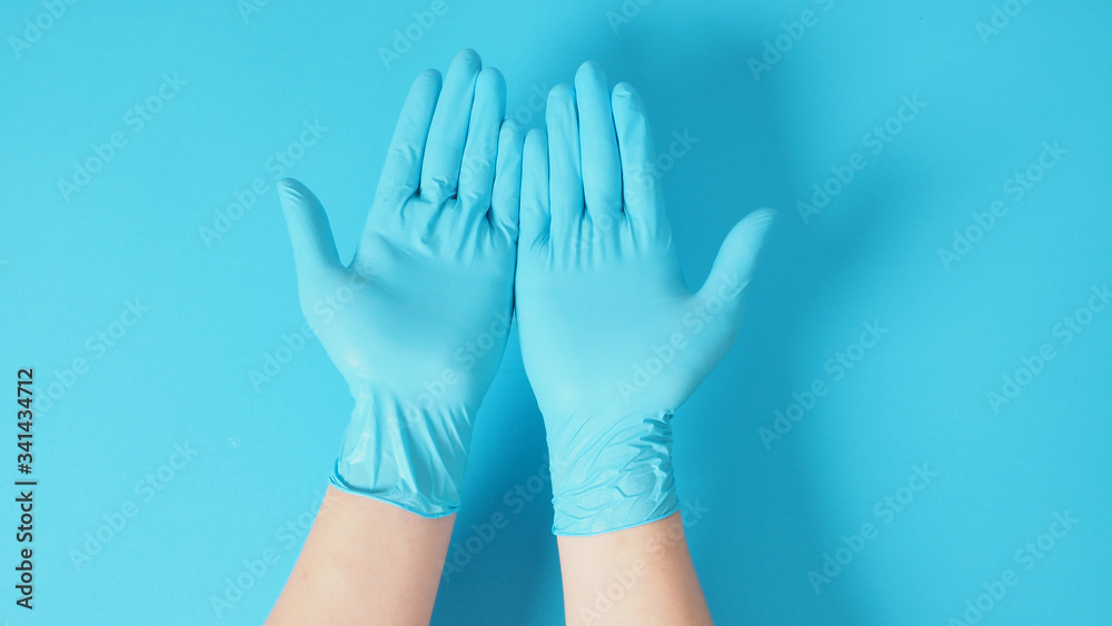 Empty two hand with doctor gloves on blue background. Empty two hand with doctor gloves on blue background.