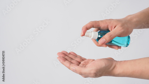 Hand is holding Alcohol Spray on white background.