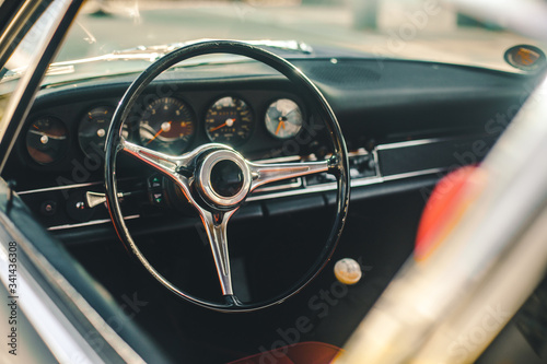Control wheel and speedometer system of a retro car, view through window