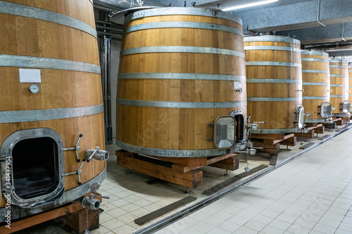 Bild auf Leinwand Large modern wine barrels at the winery, the concept of a large factory, production