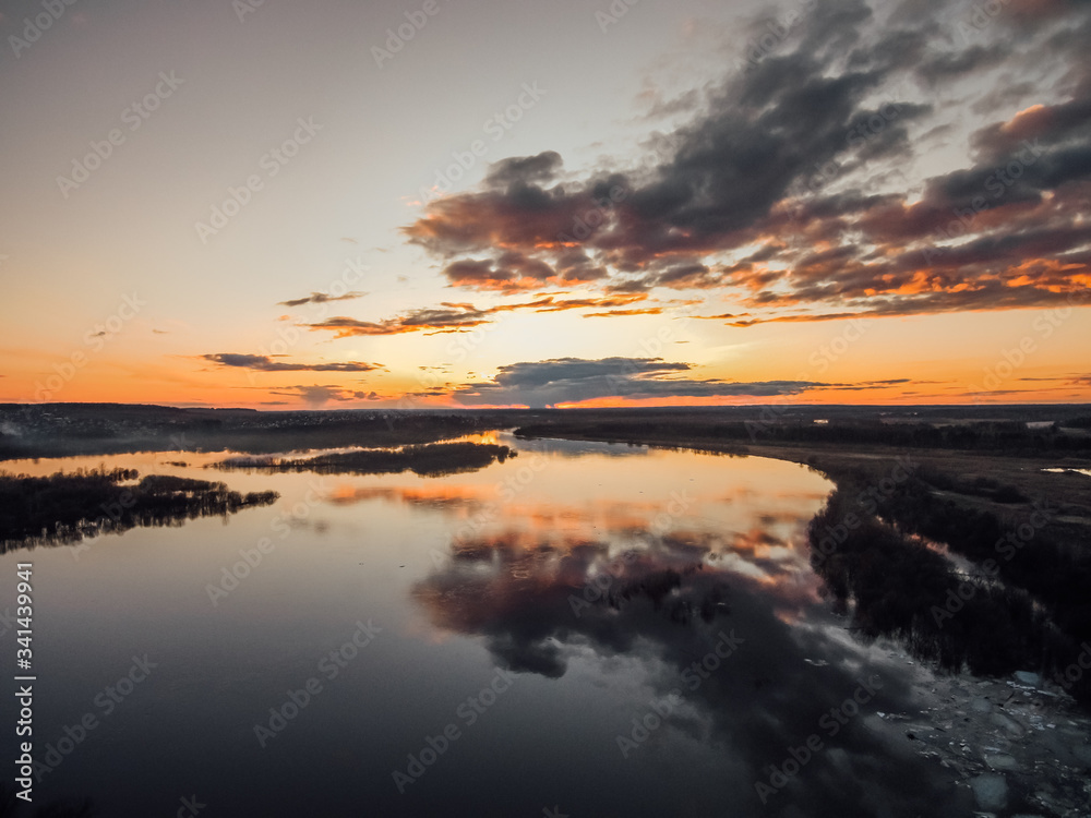 beautiful clouds at sunset reflected in the mirror surface of the river