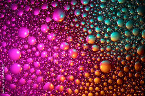 Abstract color background. Bubbles of oil in a colored liquid and lighting in macro photography. Creative and art concept © uladzimirzuyeu