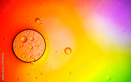 Abstract color background. Bubbles of oil in a colored liquid and lighting in macro photography. Creative and art concept