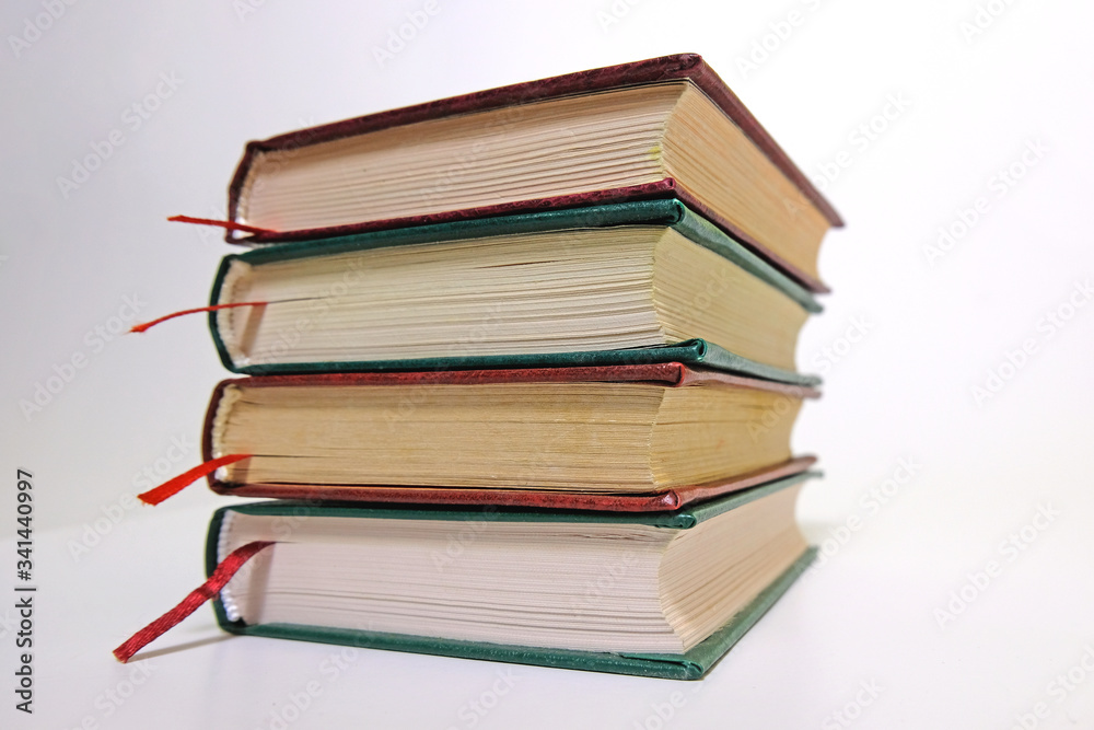 Book stack on a white background with bookmarks on classic, vintage style Book stack on a white background with bookmarks on classic, vintage style
