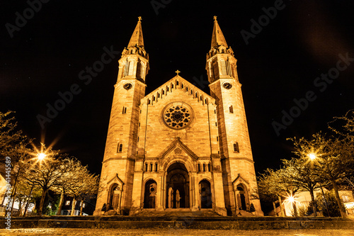 Night lights of park and evangelical church in Forbach village