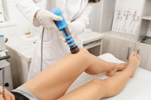 Extracorporeal Shockwave Therapy ESWT. Effective non-surgical treatment for pain. Physical therapy of knee with shock waves. Pain relief  normalization and regeneration  stimulation of healing process
