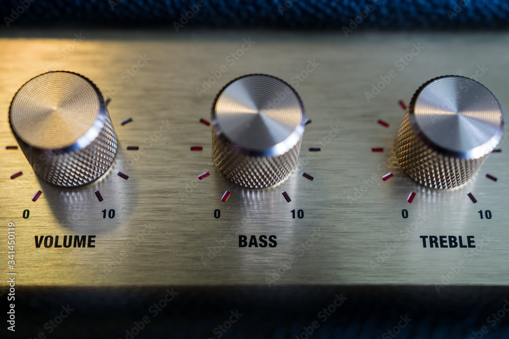 knobs of guitar amplifier in gold