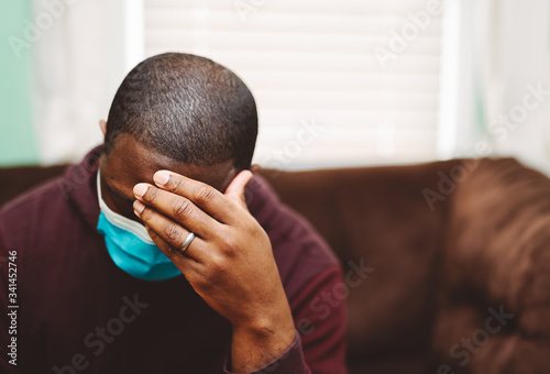 african american man in blue and white surgical  face mask