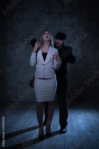 Film noir. Hitman strangled the beautiful businesswoman with black cord
