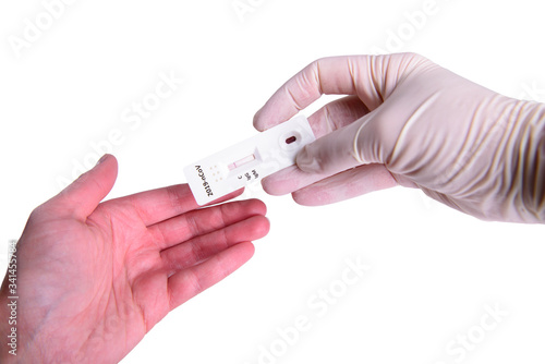 Rapid Covid-19 coronavirus strip test cassette for antibody or sars-cov-2 virus disease in hands epidemic concept isolated on white background close-up