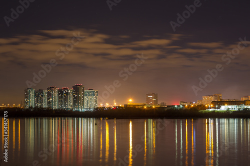 Night city lights reflected in the river. Nizhny Novgorod, the river Oka.