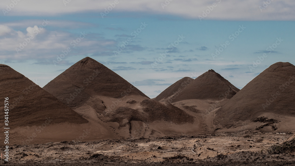 Dark volcano mountains under a blue summer sky