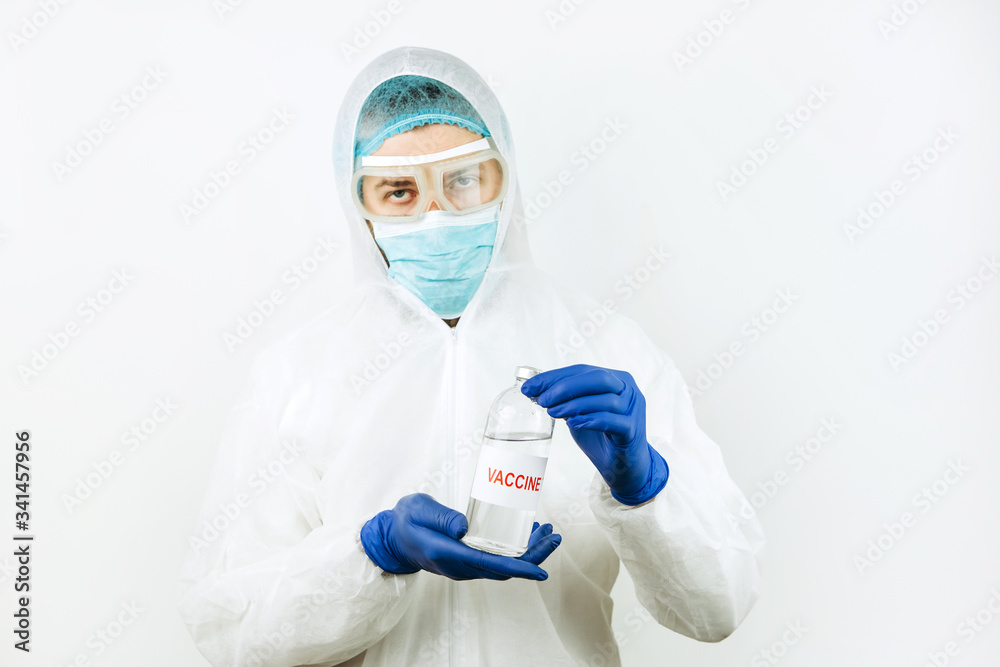 A doctor in a white coat and blue gloves holds a syringe test tube with a coronavirus vaccine. Covid 2019 vaccine injection. 2020 pandemic coronavirus. Vaccine test. A doctor in a white coat and blue gloves holds a syringe test tube with a coronavirus vaccine. Covid 2019 vaccine injection. 2020 pandemic coronavirus. Vaccine test.