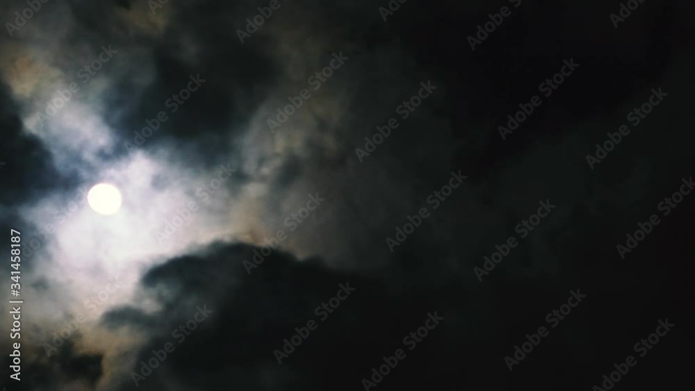 Night sky. Mystery clouds moves through the full moon. Occultism rituals. Creepy atmosphere Night sky. Mystery clouds moves through the full moon. Occultism rituals. Creepy atmosphere